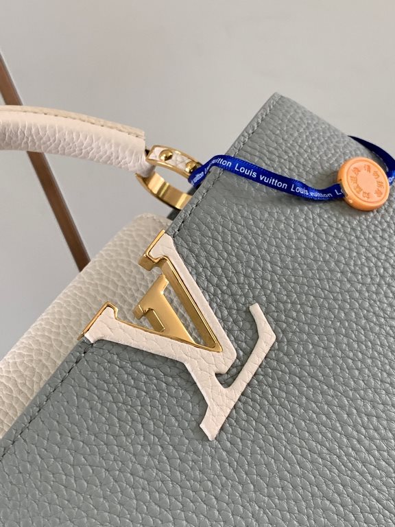 M59465 Minaret Gray with Pearl Platinum Buckle]A modern clash of shades in full-grain cowhide leather, this Capucines BB bag features the iconic LV alphabet and side loops, top handles and a detachable shoulder strap for