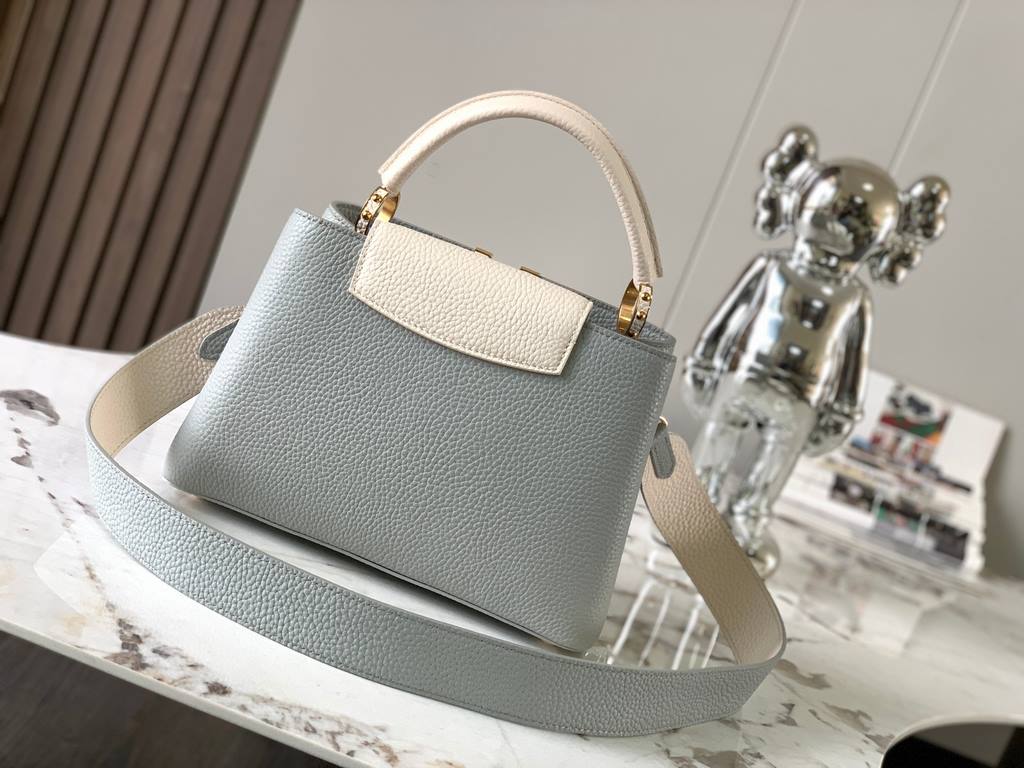 M59465 Minaret Gray with Pearl Platinum Buckle]A modern clash of shades in full-grain cowhide leather, this Capucines BB bag features the iconic LV alphabet and side loops, top handles and a detachable shoulder strap for