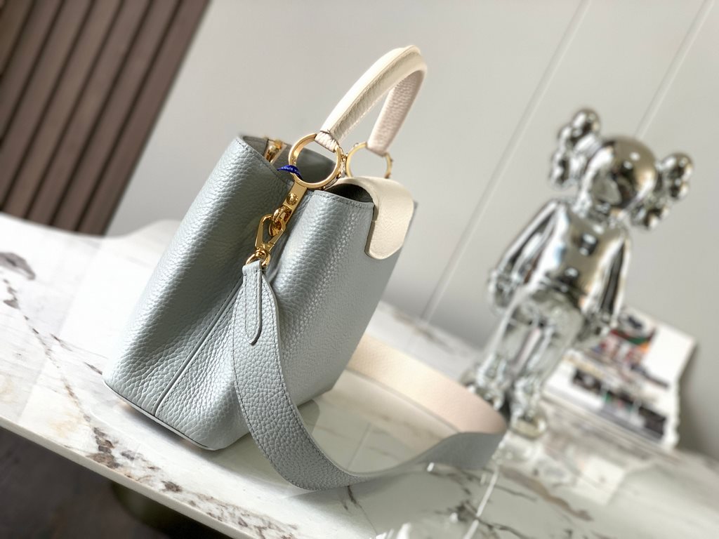 M59465 Minaret Gray with Pearl Platinum Buckle]A modern clash of shades in full-grain cowhide leather, this Capucines BB bag features the iconic LV alphabet and side loops, top handles and a detachable shoulder strap for