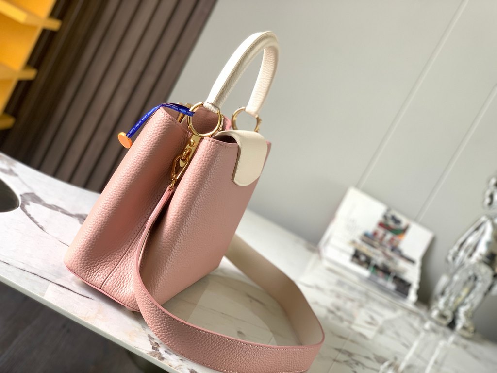 M59466 Rose Pink with Pearl Platinum Buckle]A modern clash of shades in full-grain cowhide leather, this medium Capucines bag features the iconic LV alphabet and side loops, top handles and a detachable shoulder strap fo