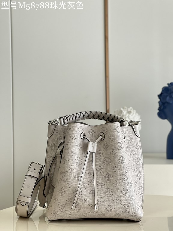 ExclusiveExclusive to M58788 in pearlized grey, this Muria bucket bag is crafted from cutout cowhide leather that lends a metallic sheen to the perforated Monogram pattern, and is finished with a leather name tag and key