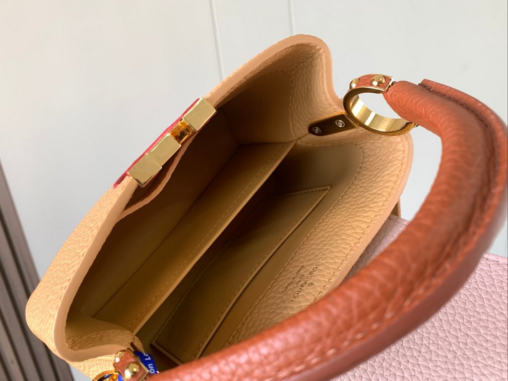 M59440 Apricot with Light Earth Gold Buckle]This Capucines mini bag is crafted from grained cowhide leather and features a color-blocked body and top handle and flap, LV lettering for visual interest, and a wide, removab