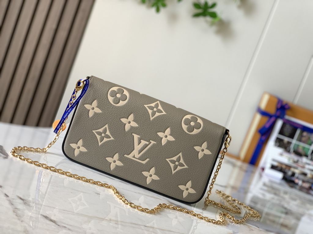 Top M69977 Elephant GrayThis Pochette Félicie chain bag in Monogram Empreinte leather with Monogram print has an envelope configuration with a removable inner pocket. It can be worn as a clutch or a shoulder bag with a c