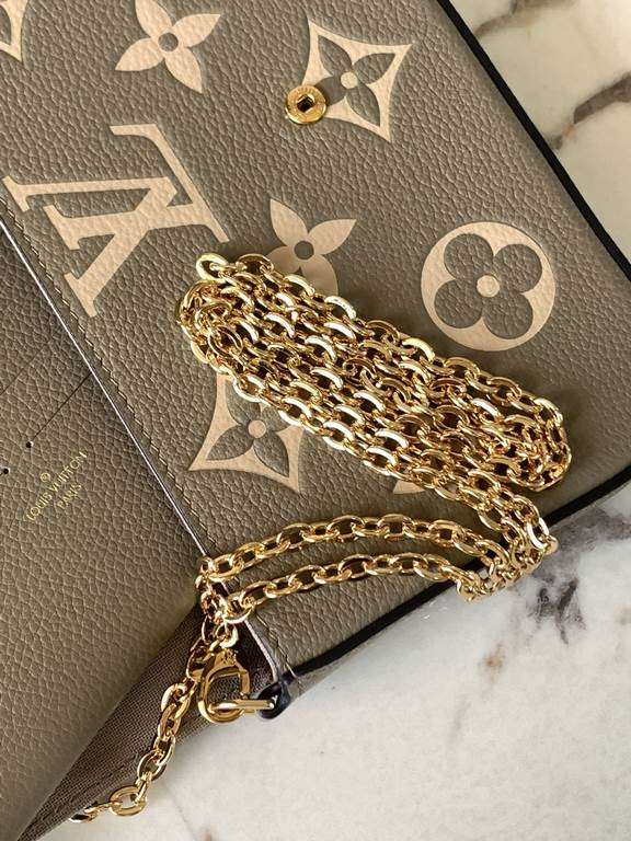 Top M69977 Elephant GrayThis Pochette Félicie chain bag in Monogram Empreinte leather with Monogram print has an envelope configuration with a removable inner pocket. It can be worn as a clutch or a shoulder bag with a c