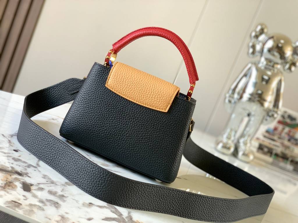 M59440 Black with Crimson Gold Buckle]This Capucines mini bag is crafted from grained cowhide leather and features a color-blocked body and top handle and flap, LV lettering for visual interest, and a wide, removable sho