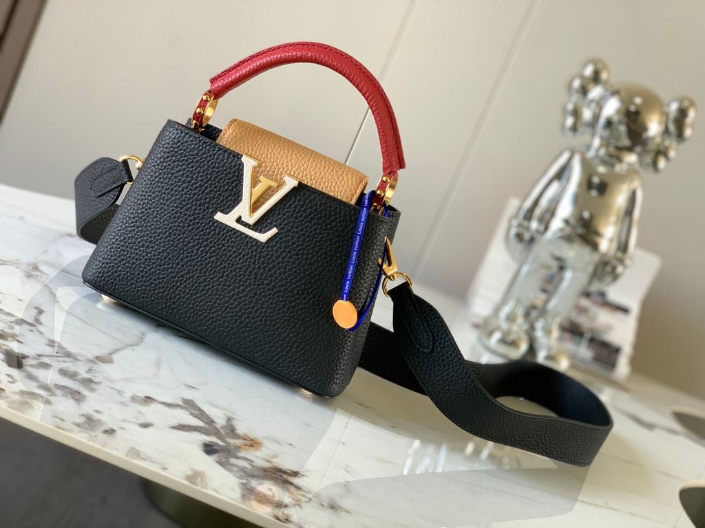 M59440 Black with Crimson Gold Buckle]This Capucines mini bag is crafted from grained cowhide leather and features a color-blocked body and top handle and flap, LV lettering for visual interest, and a wide, removable sho