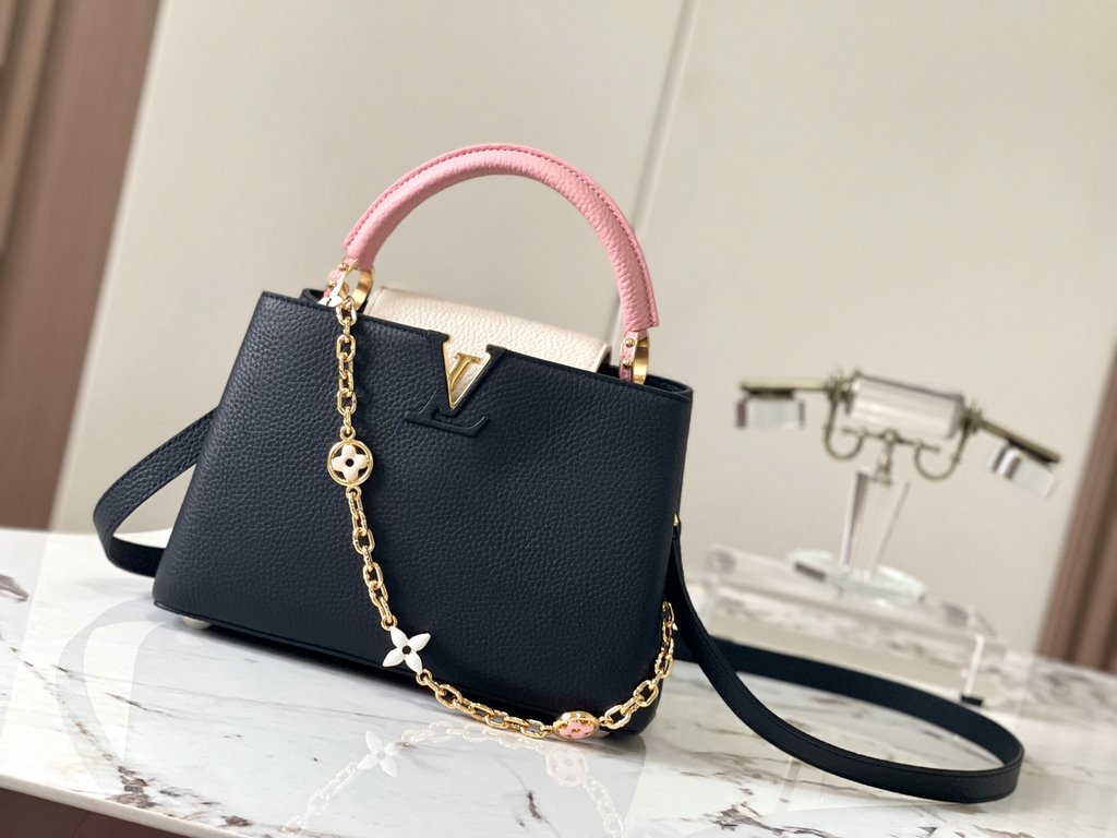 ExtraordinaryM20844 Black with Light Cherry Blossom Pink Floral TricotThis Capucines BB bag is made of Taurillon leather, with shades of the same color, making the classic shape even more striking. With an enameled Monog