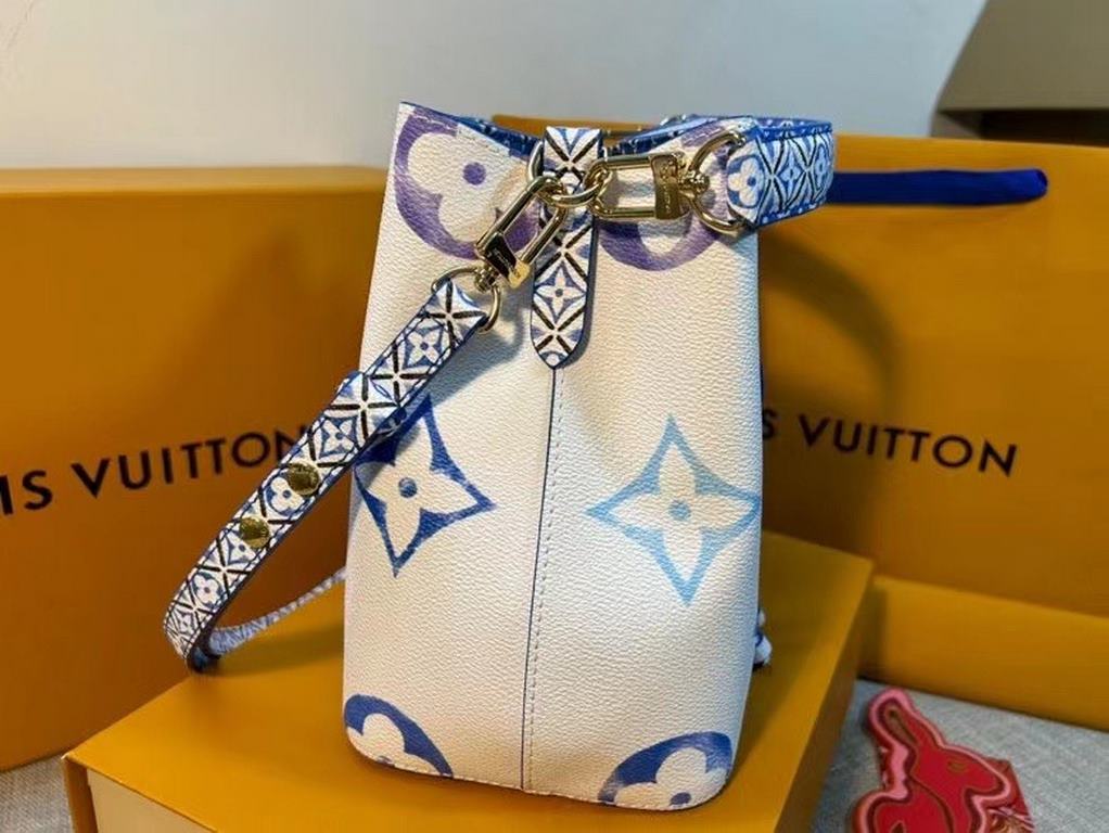 The new M22986 NeoNoé Bucket Bag in blue is made of muted canvas with a Giant Monogram print, giving the LV and Monogram florals a watercolor effect in varying shades, and features a drawstring and central snap closure i