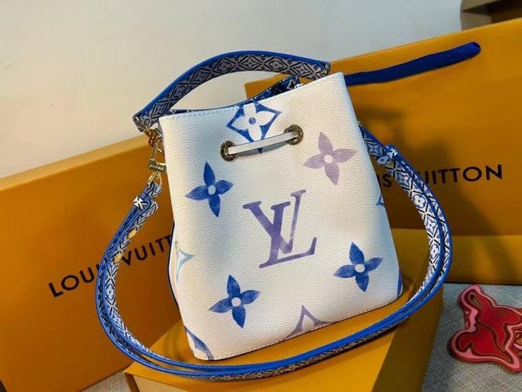 The new M22986 NeoNoé Bucket Bag in blue is made of muted canvas with a Giant Monogram print, giving the LV and Monogram florals a watercolor effect in varying shades, and features a drawstring and central snap closure i