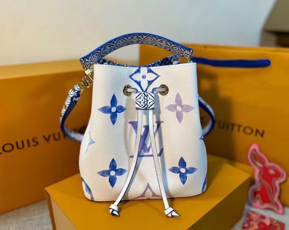 The new M22986 NeoNoé Bucket Bag in blue is made of muted canvas with a Giant Monogram print, giving the LV and Monogram florals a watercolor effect in varying shades, and features a drawstring and central snap closure i