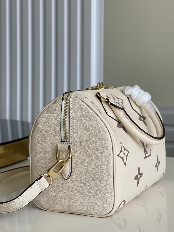 Exclusive to M58947] The Speedy Bandoulière 25 handbag from the Fall 2021 Wild at Heart capsule collection features oversized LV letters embossed in Monogram Empreinte leather and a detachable shoulder strap for a crossb