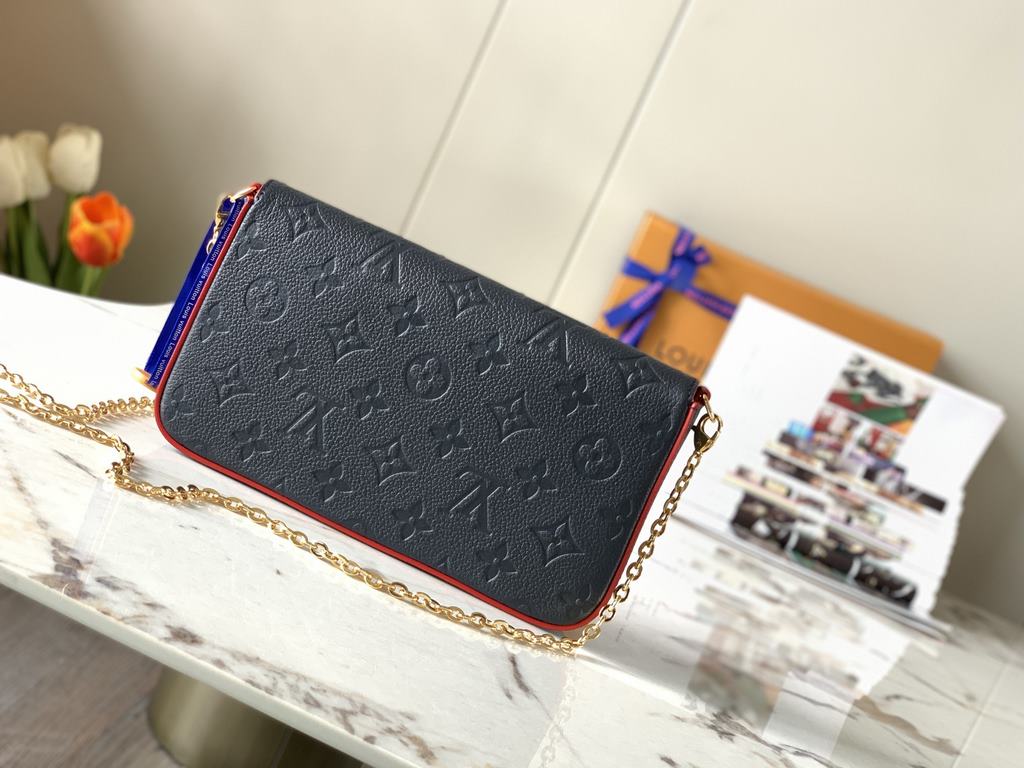 Top M64099 NavyThe Pochette Félicie chain bag is shaped like an envelope in Monogram Empreinte leather and embossed with the classic Monogram pattern. The ample compartments are complemented by a removable zipper pocket 