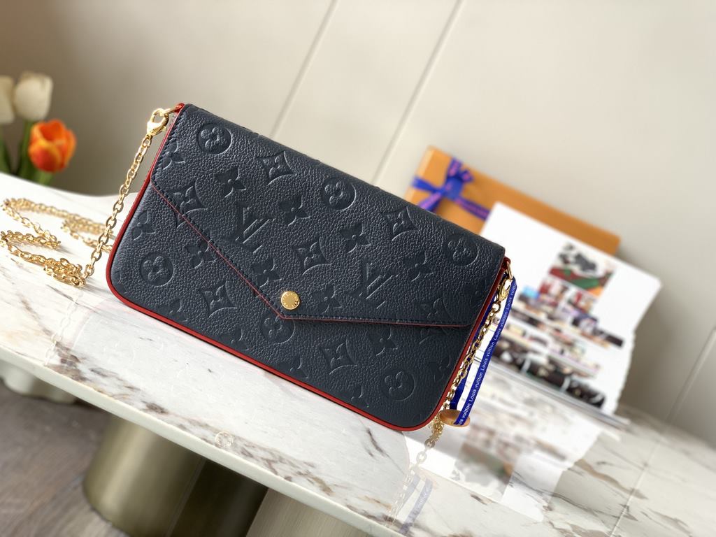 Top M64099 NavyThe Pochette Félicie chain bag is shaped like an envelope in Monogram Empreinte leather and embossed with the classic Monogram pattern. The ample compartments are complemented by a removable zipper pocket 