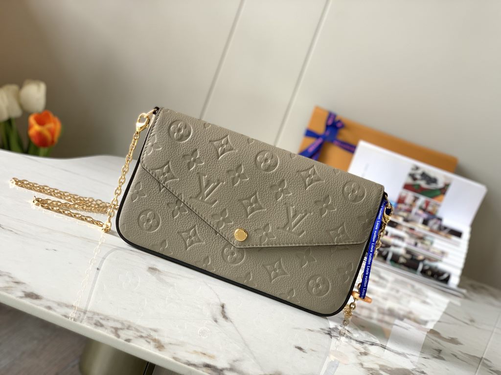 Top M68697 Elephant GrayThe Pochette Félicie chain bag is shaped like an envelope in Monogram Empreinte leather and embossed with the classic Monogram pattern. The ample compartments are complemented by a removable zippe