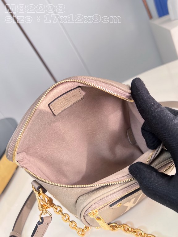 Exclusive M82208 silk-screened in light gray] Louis Vuitton's soft take on the trendy fanny pack design, the Mini Bumbag is crafted from Monogram Empreinte leather and features a zippered main compartment and zippered po