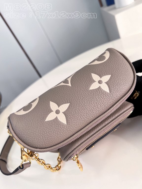 Exclusive M82208 silk-screened in light gray] Louis Vuitton's soft take on the trendy fanny pack design, the Mini Bumbag is crafted from Monogram Empreinte leather and features a zippered main compartment and zippered po