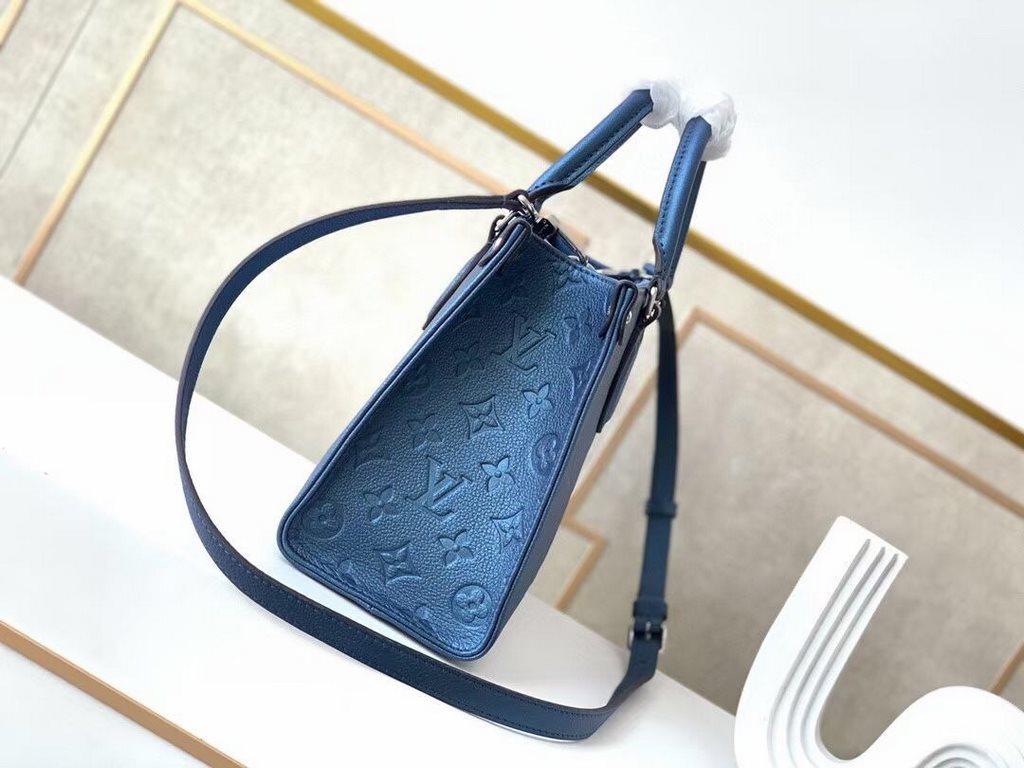 Top  M45653Blue M45661This Onthego mini shopper bag shows off the Monogram pattern to its best advantage, with large letters embossed on soft grained cowhide leather, an ample interior to hold a laptop and other office s