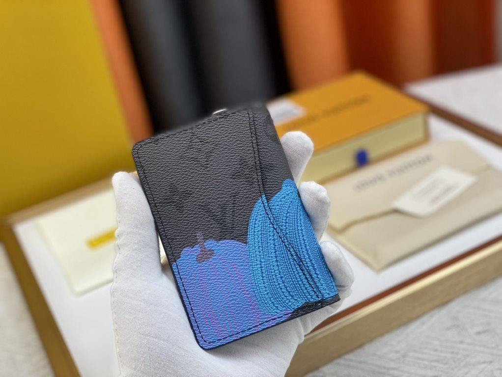 63144 Grey Flower Pumpkin   From the Louis Vuitton x Yayoi Kusama Collaboration, this LV x YK Pocket Money Clip features a colorful pumpkin motif on Monogram Eclipse Reverse canvas, recreating the symbol of warmth and so