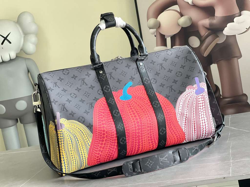 M46471, M46441 The hottest of the year, this Lv X YK Keepall 45 combines classic design with iconic details. Crafted from Damier Graphite canvas and sized for hand luggage. Featuring rounded leather handles and an adjust