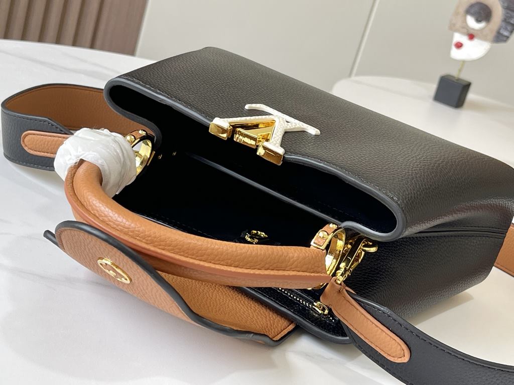 Exclusive -  M59464 Black with Almond Gold BuckleA modern clash of shades in full-grain cowhide leather, this small Capucines BB bag features the iconic LV alphabet and side loops, top handles and a detachable shoulder s