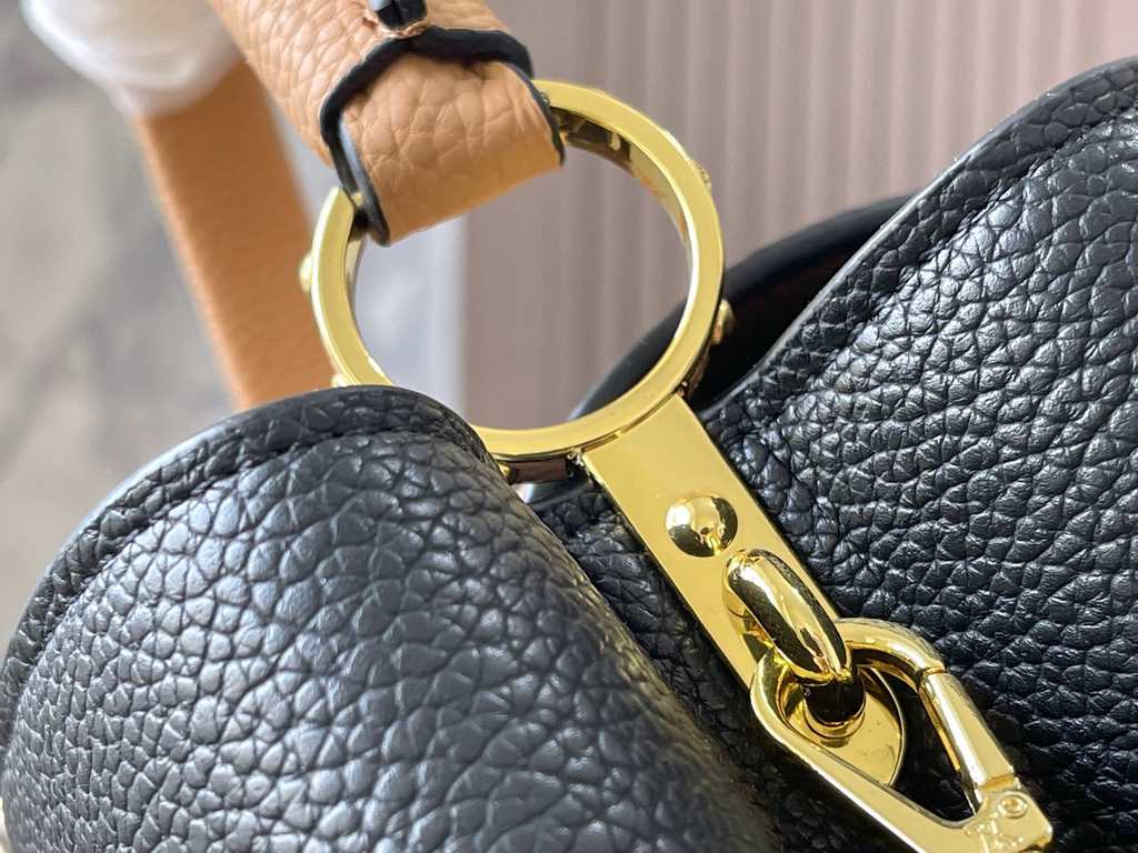 Exclusive -  M59466 Black with Almond Gold BuckleA modern clash of shades in full-grain cowhide leather, this medium Capucines bag features the iconic LV alphabet and side loops, top handles and a detachable shoulder str