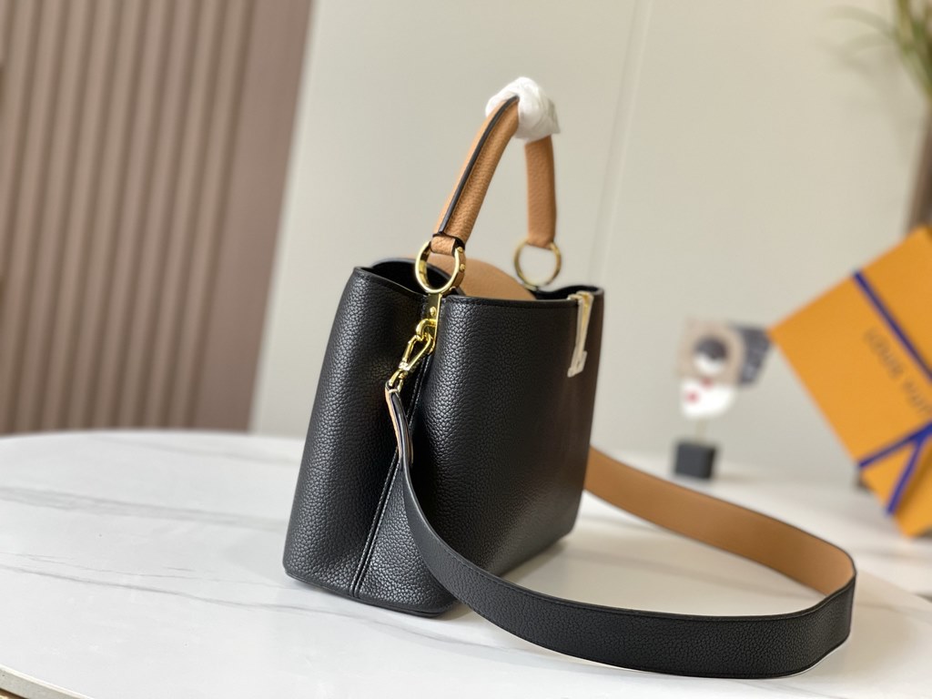 Exclusive -  M59466 Black with Almond Gold BuckleA modern clash of shades in full-grain cowhide leather, this medium Capucines bag features the iconic LV alphabet and side loops, top handles and a detachable shoulder str