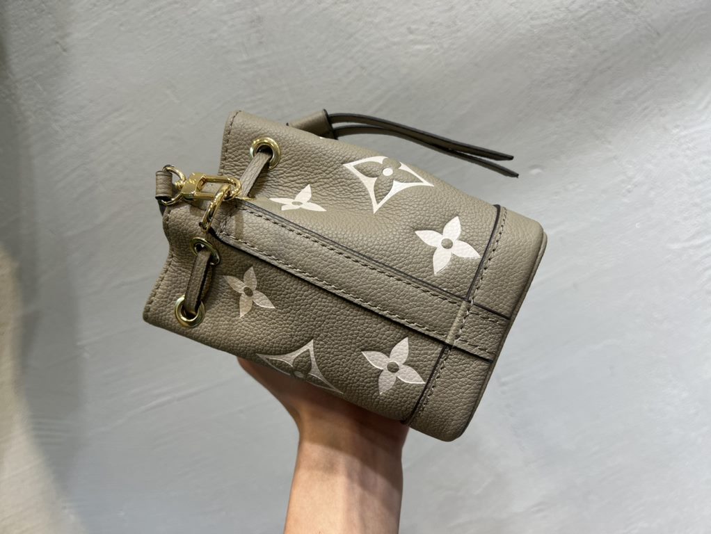 M46291 Grey Grams This Nano Noé bag is printed and embossed in leather with LV's alphabet and Monogram florals for an eye-catching look that will captivate the eye. Plenty of room for your daily needs, with an adjustable