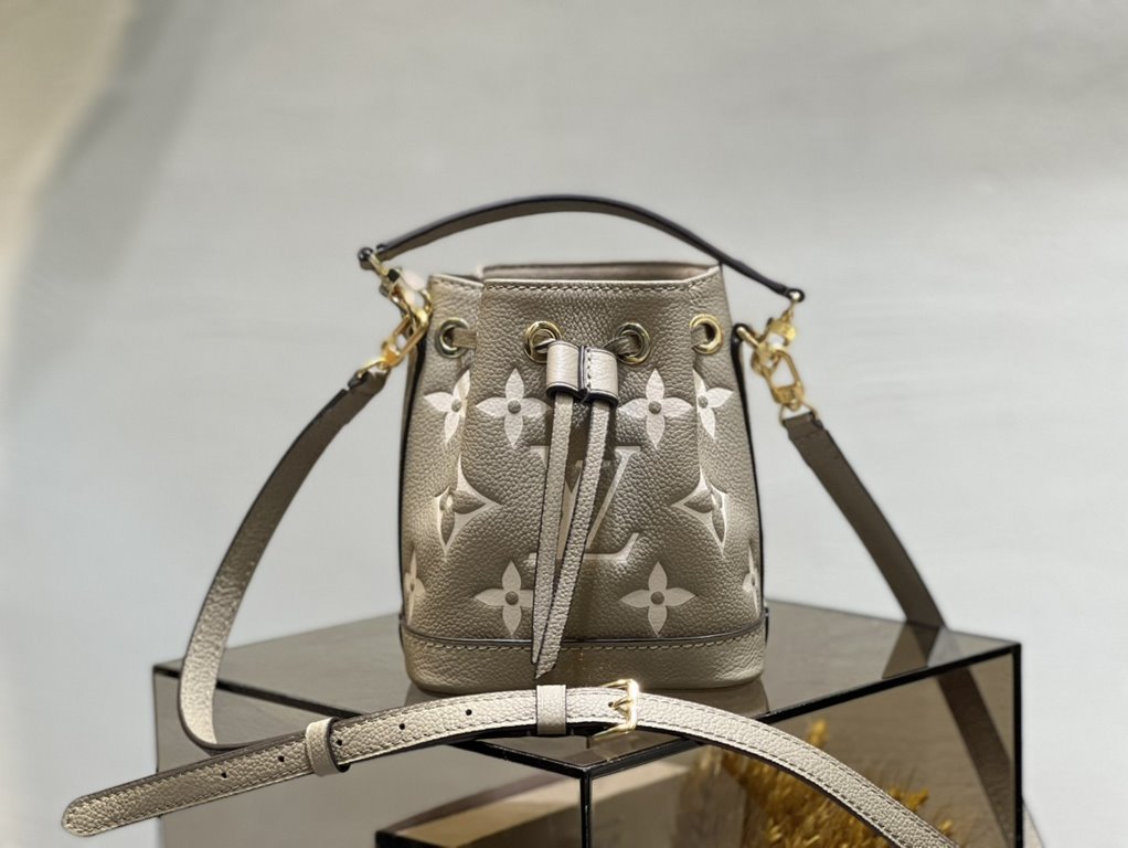 M46291 Grey Grams This Nano Noé bag is printed and embossed in leather with LV's alphabet and Monogram florals for an eye-catching look that will captivate the eye. Plenty of room for your daily needs, with an adjustable