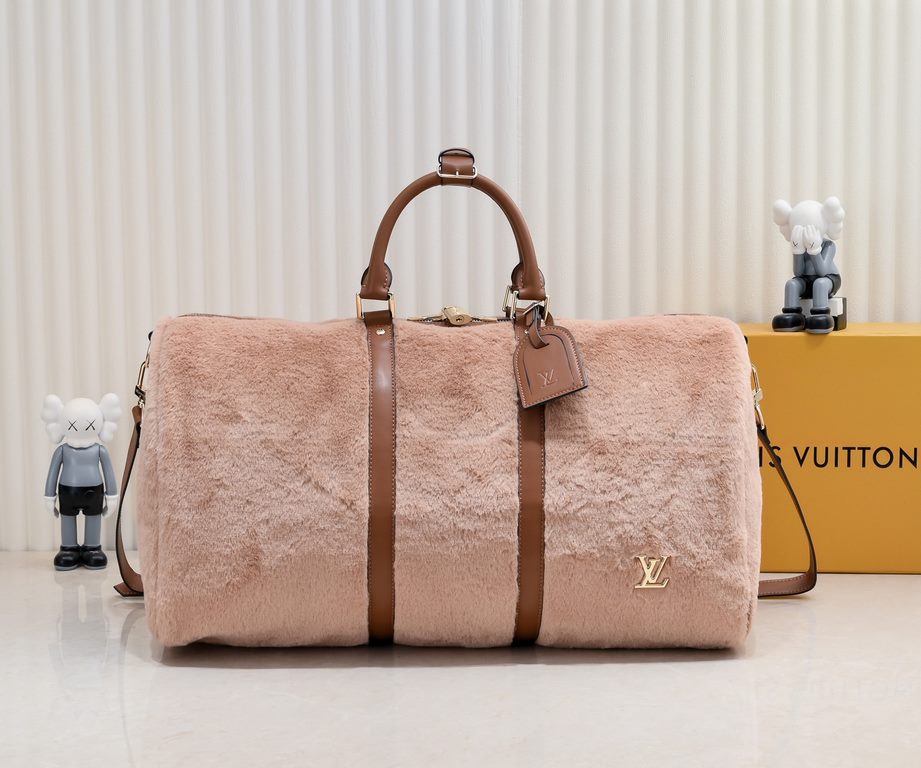 EXCLUSIVE ACTUAL - UPGRADED  M23108 The Puffy Shearling Keepall Bandoulière 50 Travel Bag is inspired by the soft touch of a teddy bear, injecting childlike fun into a functional piece. The wool-leather body features cow