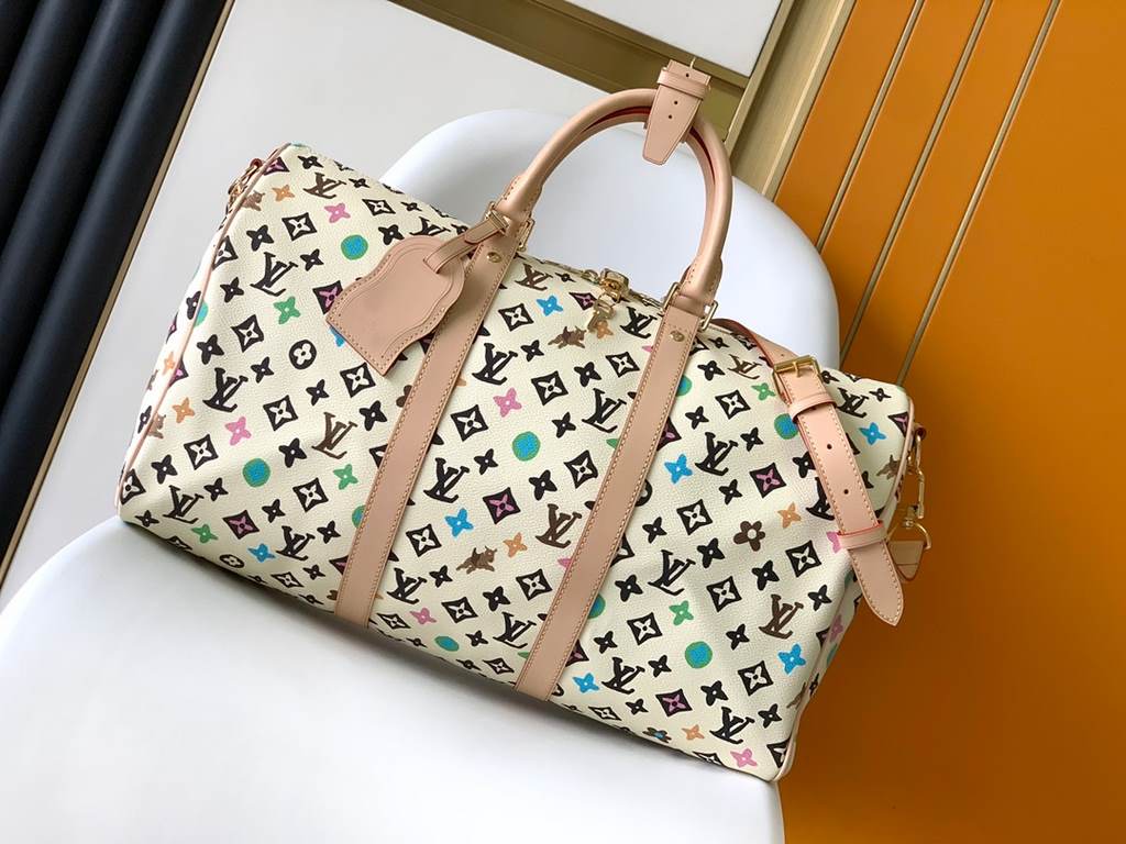 M24901 Black M24233 White The hottest of the year, this Lv X YK Keepall 50 combines classic design with iconic details. Crafted from Damier Graphite canvas and sized for hand luggage. Featuring rounded leather handles an