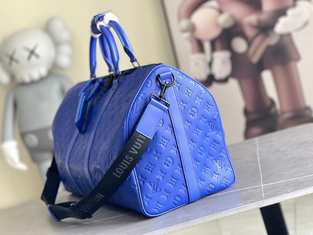 Top Original M23141 Indigo (Embossed) Full Leather Travel Bag Collection Keepall Bandoulière 50 Travel Bag One of Louis Vuitton's iconic travel bags, the Keepall Bandoulière 50 Travel Bag is a tough, embossed Taurillon l