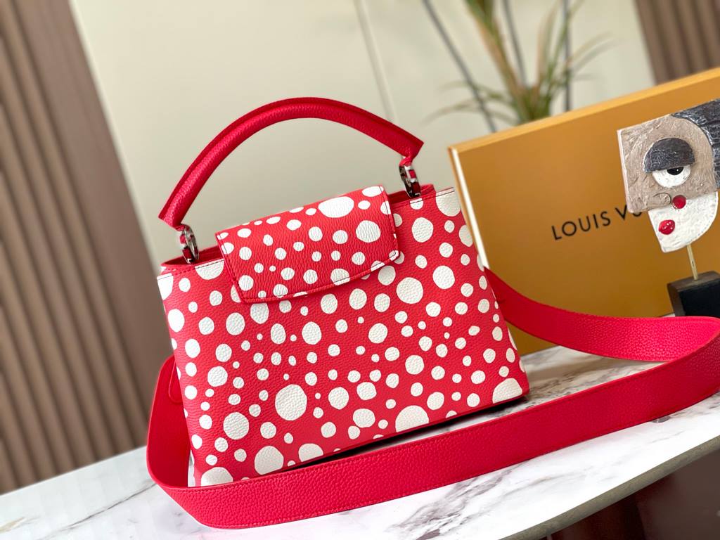 EXCLUSIVE SHOOTING - M21665 From the Louis Vuitton x YK Capucines collaboration, this medium-sized LV x Yayoi Kusama bag is a dazzling expression of the famous Japanese artist's childhood obsession with polka dots as a s