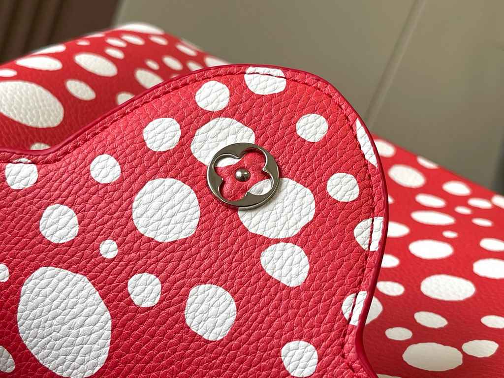 EXCLUSIVE SHOOTING - M21665 From the Louis Vuitton x YK Capucines collaboration, this medium-sized LV x Yayoi Kusama bag is a dazzling expression of the famous Japanese artist's childhood obsession with polka dots as a s