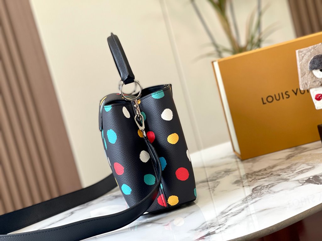 EXCLUSIVE SHOOTING - M21665 From the Louis Vuitton x YK Capucines collaboration, this medium-sized LV x Yayoi Kusama bag is a dazzling expression of the famous Japanese artist's childhood obsession with polka dots as a s