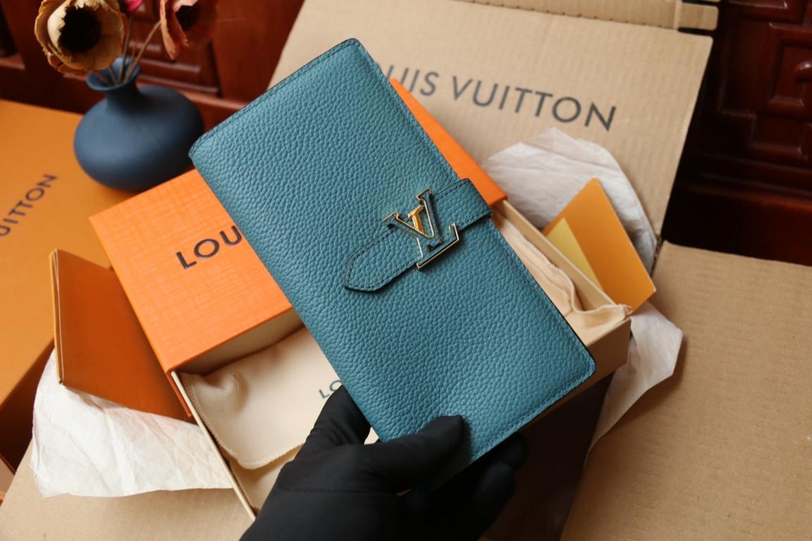 M81330This LV Vertical walletInspired by Capucines handbags, this wallet in soft grained Taurillon leather is embellished with LV letters for the sliding closure. It opens to reveal a color-blocked lining and features a 