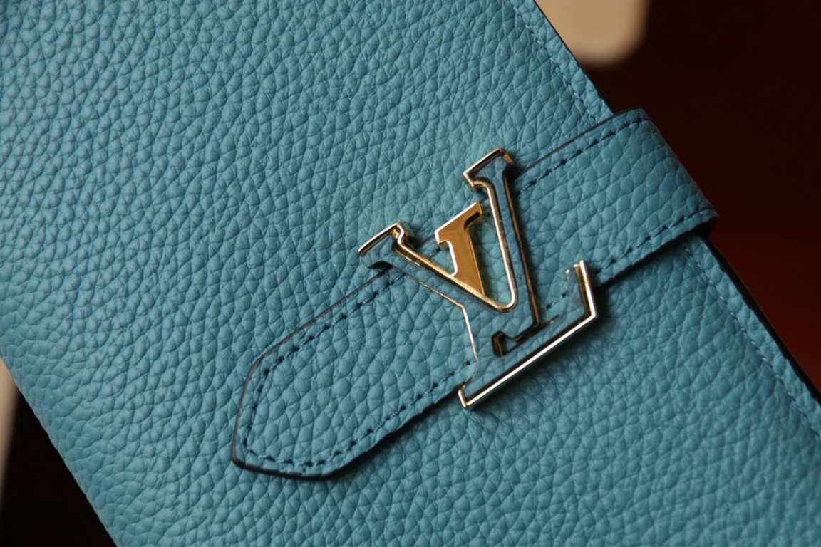 M81330This LV Vertical walletInspired by Capucines handbags, this wallet in soft grained Taurillon leather is embellished with LV letters for the sliding closure. It opens to reveal a color-blocked lining and features a 