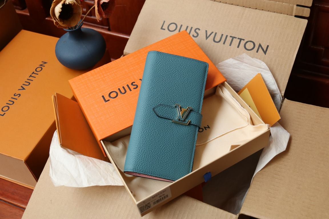 M81330This LV Vertical walletInspired by Capucines handbags, this wallet in soft grained Taurillon leather is embellished with LV letters for the sliding closure. It opens to reveal a color-blocked lining and features a 