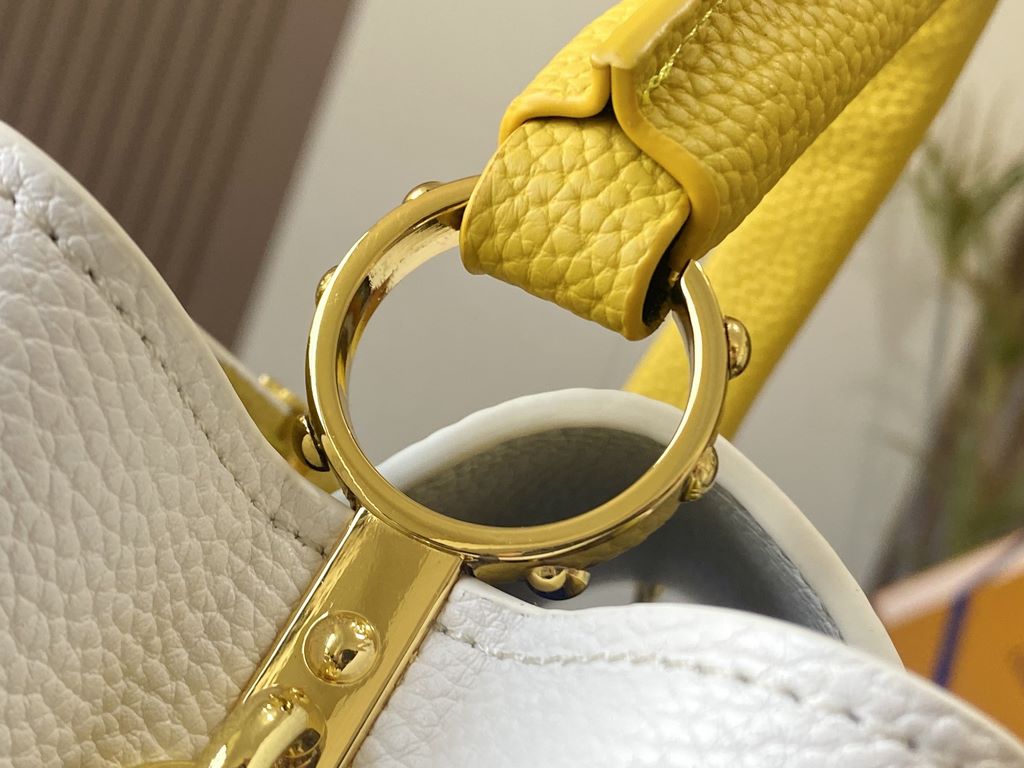 EXCLUSIVE PHOTO - M59434This medium Capucines BB handbag is shaped in full-grain cowhide leather in the compact size of the Capucines collection, with LV's letters, signature side loops, and a floral Monogram flap.Detail