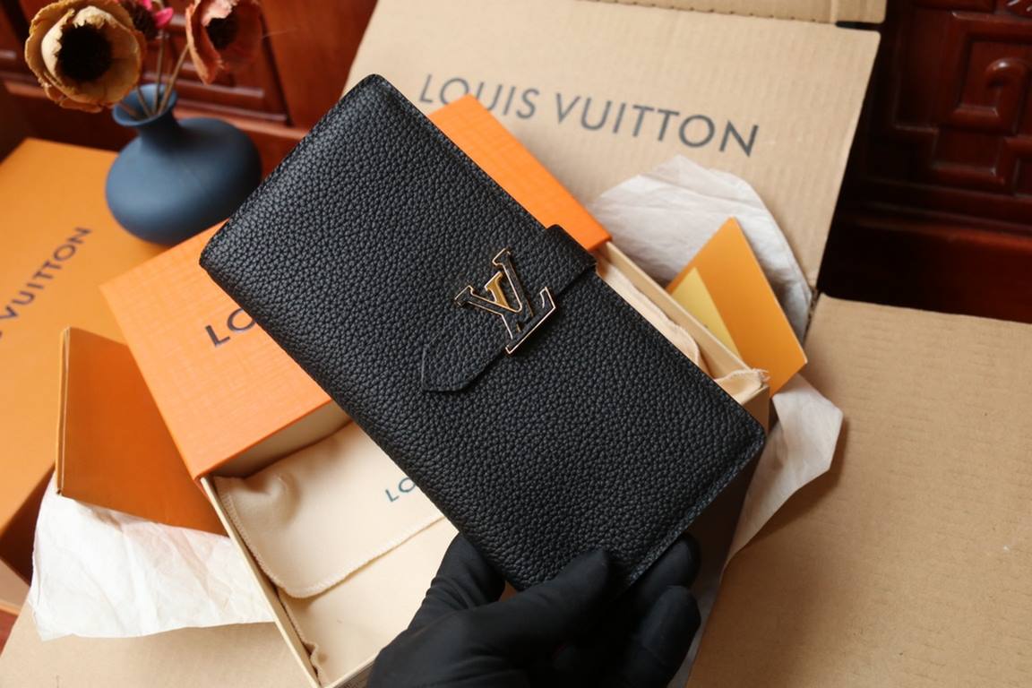 M81330This LV Vertical walletInspired by Capucines handbags, this wallet in soft grained Taurillon leather is embellished with LV letters for the sliding closure. It opens to reveal a color-blocked lining and features a 