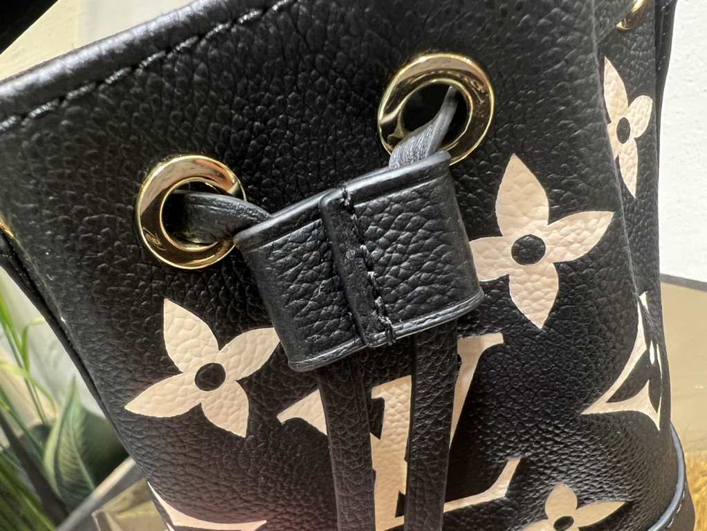 M46291 Grey Grams This Nano Noé bag is printed and embossed in leather with LV's alphabet and Monogram florals for an eye-catching look that will captivate the eye. Plenty of room for your daily needs, with an adjustable