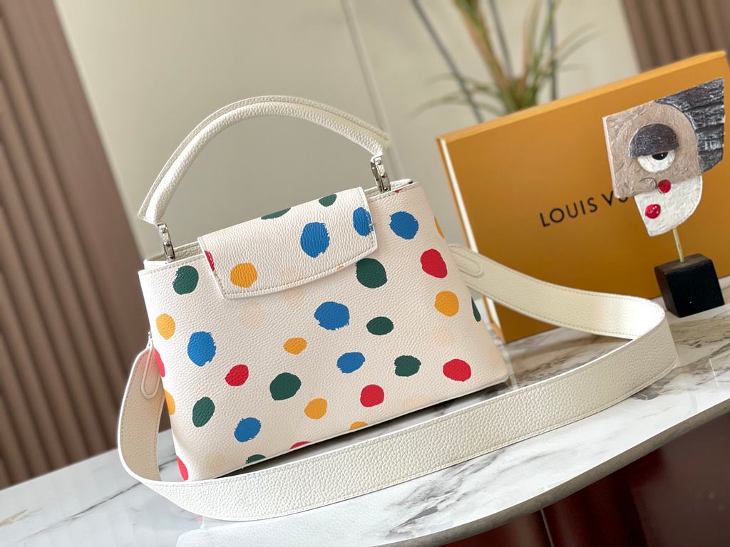 EXCLUSIVE SHOOTING - M21665 From the Louis Vuitton x YK Capucines collaboration, this medium-sized LV x Yayoi Kusama bag is a dazzling expression of the famous Japanese artist's childhood obsession with polka dots as a s