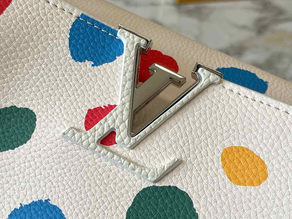 EXCLUSIVE SHOOTING - M21665 From the Louis Vuitton x YK Capucines collaboration, this medium-sized LV x Yayoi Kusama bag is a dazzling expression of the famous Japanese artist's childhood obsession with polka dots as a s