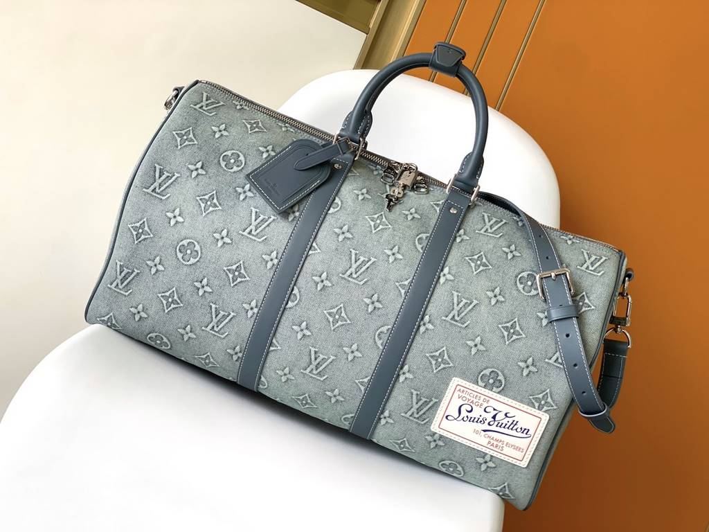 ￥  Top Original M22532 Denim This Keepall Bandoulière 50 travel bag is embossed with a Monogram pattern in faded denim, reinventing one of Louis Vuitton's classic designs. The reinforced side straps and top handle are ma