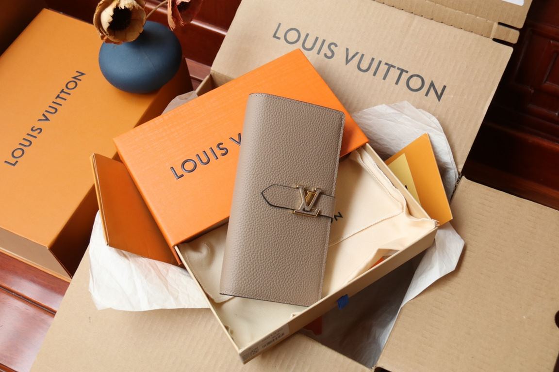 M81330This LV Vertical walletInspired by Capucines handbags, this wallet in soft grained Taurillon leather is embellished with LV letters for the sliding closure. It opens to reveal a color-blocked lining and features a 