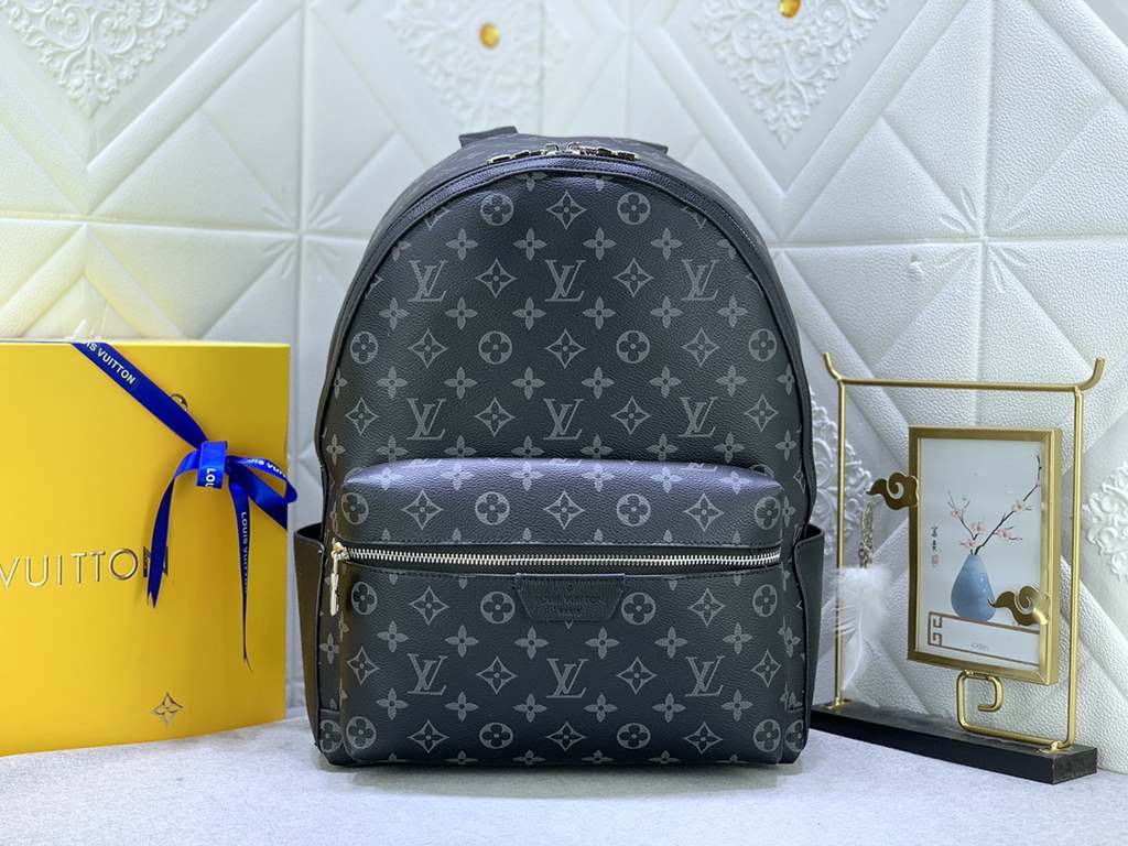 Upgraded from the original M46553 Black Flower Embossed This Discovery duffel bag is made of soft Monogram Eclipse coated canvas fabric with the subdued touch of metal pieces. The exterior pockets provide easy access to 