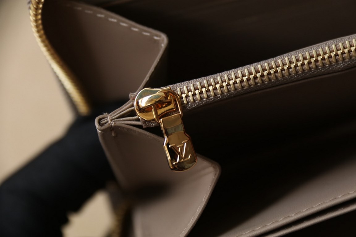 This Zipper WalletM81510Sewn in padded Monogram embossed lambskin, it complements the Coussin Leather Collection. Elegantly designed with a gold-tone zipper embellished with the LV Circle logo pull, the all-in-one wallet