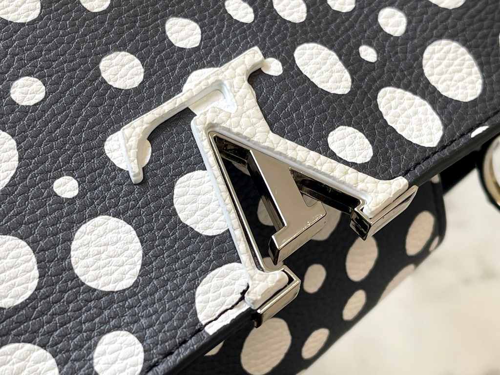 EXCLUSIVE SHOOTING - M21665 From the Louis Vuitton x YK Capucines collaboration, this medium-sized LV x Yayoi Kusama bag is a dazzling expression of the famous Japanese artist's childhood obsession with polka dots as a s