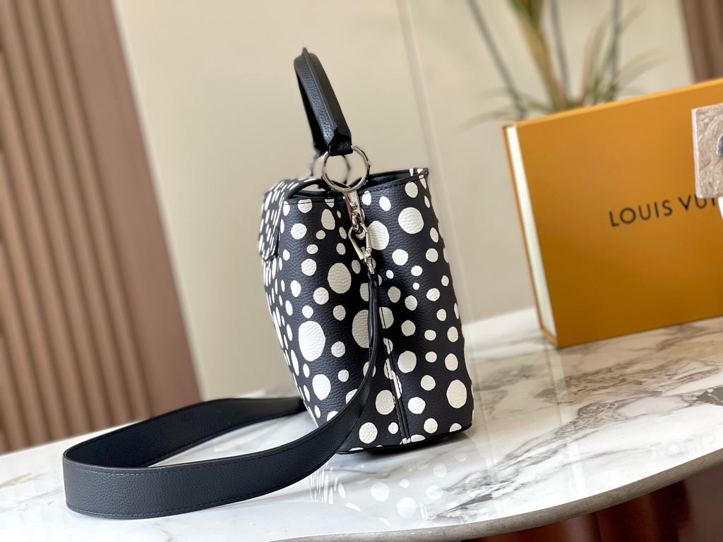 EXCLUSIVE SHOOTING - M21665 From the Louis Vuitton x YK Capucines collaboration, this medium-sized LV x Yayoi Kusama bag is a dazzling expression of the famous Japanese artist's childhood obsession with polka dots as a s