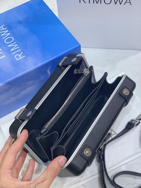 DIR X RIMOWA Capsule Collaboration CollectionUltra Limited EditionA lot of goodwill  My heart  Small but very  lovely. Super practical,Total  3 compartments. The size of a handbag.It can definitely fit an Iphone proMax [