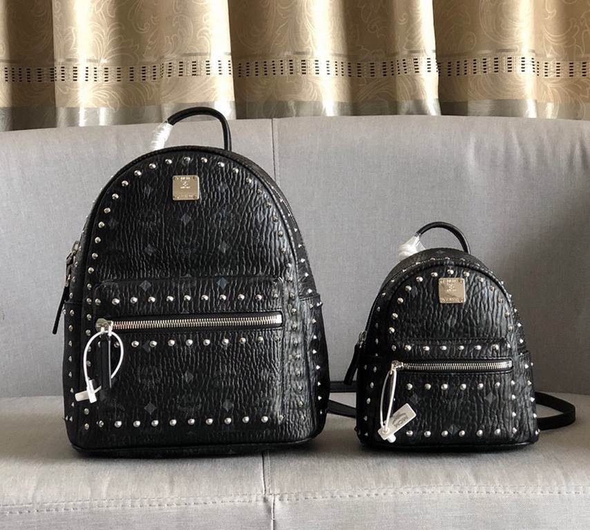 Code 5917-5718-5919. [MCM] Stark Visetos studded duffel bag in a classic Visetos print with metal rivets outlining the print. Crafted from lightweight bond-coated canvas and designed in a classic Visetos print, the pract